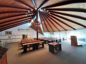a large dining room with wooden ceilings and tables at Hotel Ovit in Keszthely +34 photos
