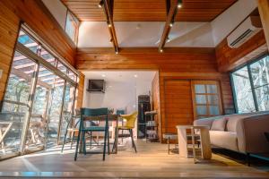 a living room with a table and chairs at rinne 北軽井沢 Forest2 in Tsumagoi