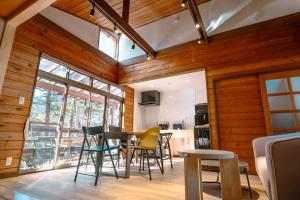 a room with wooden walls and a table and chairs at rinne 北軽井沢 Forest2 in Tsumagoi