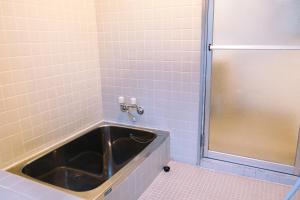 a bathroom with a tub and a shower stall at rinne 北軽井沢 Forest2 in Tsumagoi +31 photos