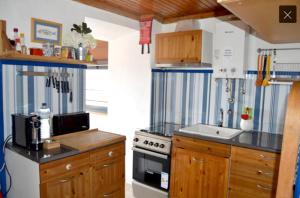a kitchen with a sink and a stove in it at Casa do Porto da Horta in Horta
