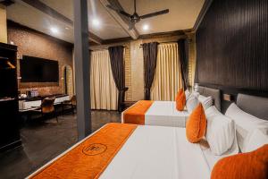 a hotel room with two beds and a television at Arama Transit Hotel in Katunayaka +34 photos