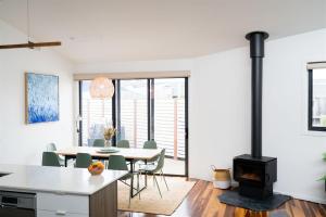a kitchen and dining room with a wood stove at The Retreat Inverloch in Inverloch