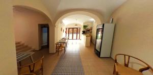 a kitchen with a refrigerator and a table and chairs at Hostal Aquaforum in Mérida