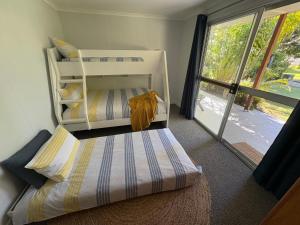 a bedroom with two bunk beds and a large window at Cowan Lodge in Cowan Cowan