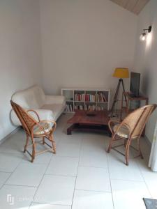 a living room with two chairs and a couch at Bordeneuve in Le Passage