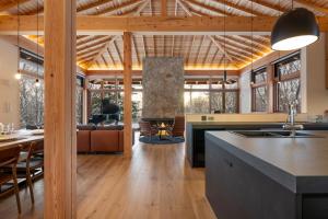a kitchen and living room with a table and a fireplace at Kogetsu To 湖月燈 in Lake Toya