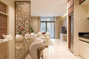 a kitchen and living room with a table and chairs at La Mirada New Cairo in Cairo