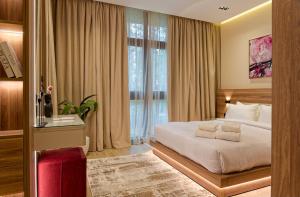 a bedroom with a bed and a large window at La Mirada New Cairo in Cairo +23 photos