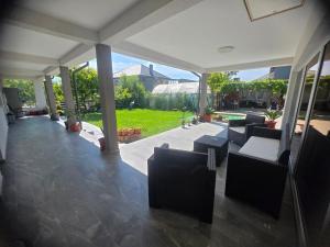 a patio with couches and a view of a yard at Casa Matei Gabriel in 2 Mai