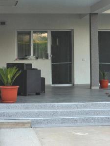 a front porch of a house with a front door at Casa Matei Gabriel in 2 Mai
