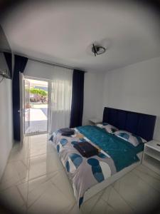 a bedroom with a large bed and a window at Casa Matei Gabriel in 2 Mai