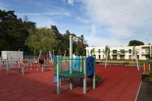 a playground with a bunch of different colored equipment at Pino 34 Sobieszewo in Gdańsk +8 photos