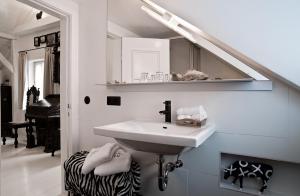 a bathroom with a sink and a mirror at Boutique Hotel Haus Noge in Westerland +54 photos