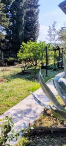 a plant in a garden next to a sidewalk at Magnolia Garden, 12 min walk to the beach in Ankaran +6 photos
