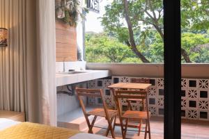 a kitchen with a table and chairs and a window at OnsenHouse Boutique Stay - Căn hộ gần biển Mỹ Khê in Danang