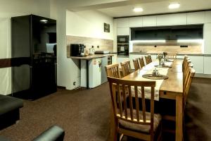 a kitchen with a large wooden table and chairs at Penzion Horalka in Hlinsko