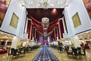 a banquet hall with tables and chairs and a chandelier at Hotel Banana Tree & Banquets 5 Min From Anand Vihar Bus Terminal and Vaishali Metro Station in Ghaziabad