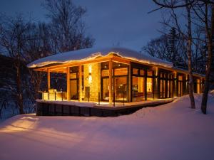 a home in the snow with a dome at Kogetsu To 湖月燈 in Lake Toya