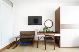 a room with a desk and a mirror and a table at Sunday Lotus Garden Resort By The Sea Mui Ne in Mui Ne +96 photos