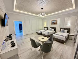 a living room with two beds and a table and chairs at Isakhoja Boutique Hotel in Khiva +99 photos