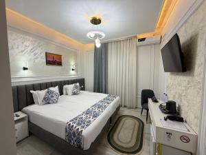 a hotel room with a bed and a television at Isakhoja Boutique Hotel in Khiva