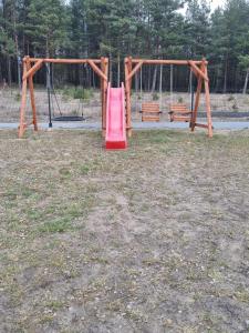 a playground with a pink slide in a park at Pokój 2osobowy in Swornegacie