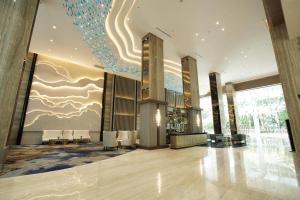 a lobby of a building with a ceiling at Wyndham Panbil Batam in Batam Center