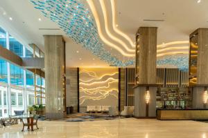 a lobby of a hotel with a chandelier at Wyndham Panbil Batam in Batam Center