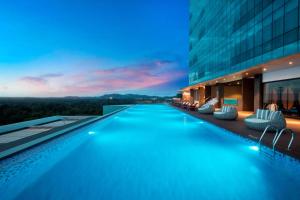 a swimming pool in the middle of a building at Wyndham Panbil Batam in Batam Center