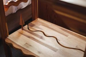 a wooden table with a wooden stick on it at Hakuba Pension & Log Hotel Meteor in Hakuba +246 photos