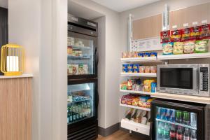 a refrigerator with its door open and a microwave at Spark by Hilton Douglasville Atlanta West in Douglasville