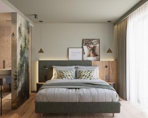 a bedroom with a large bed and a large window at Ziach & Candy Grossarl in Grossarl