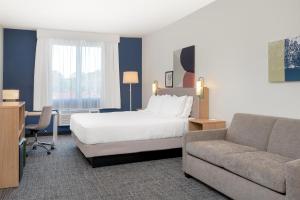 a hotel room with a bed and a couch at Spark by Hilton Douglasville Atlanta West in Douglasville +23 photos