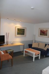 a living room with a couch and a table at RB Hotel Linde in Wangen