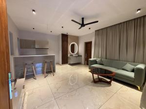 a living room with a couch and a table at Kaveri Pool Pavilion in Paravūr