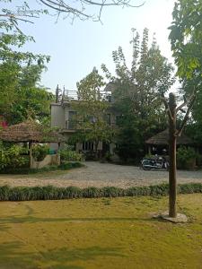 a house with a motorcycle parked in front of it at Narayani View Resort in Bharatpur