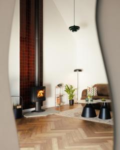 a living room with a fireplace and a table at Folga in Tarnawa Dolna