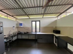 a large kitchen with a large counter in a room at Infinity Farm Grove in Olavakod Junction