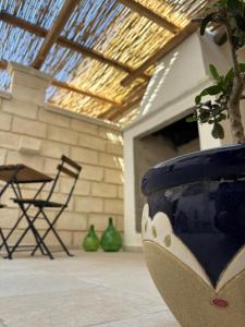 a large blue vase with a plant in a room at Cortile di Nonna in Sammichele di Bari