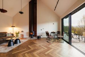 a living room with a couch and a fireplace at Folga in Tarnawa Dolna