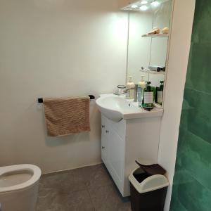 a bathroom with a white sink and a toilet at Blu Corner in Lian