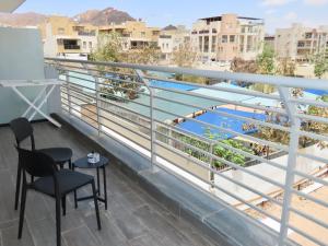 a balcony with chairs and a view of the water at דיויד רזידנט & ספא - by Desert 360 Mountain & sea view in Eilat