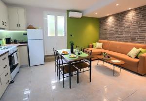 a kitchen and living room with a table and a couch at Olive Groove Chios in Chios