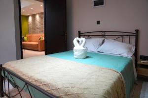 a bedroom with a bed with a swan statue on it at Olive Groove Chios in Chios