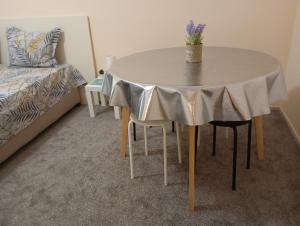 a white table with a vase on it in a bedroom at ADELA Apartment center city in Ruse +10 photos