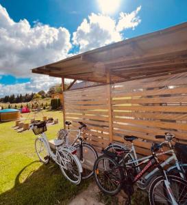 a group of bikes parked under a shed at Dom BAnia Mazury SPA in Kukowo