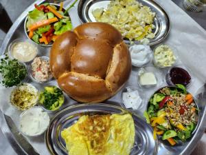 a table topped with different types of food on a table at קסם המעיינות in Bet Sheʼan