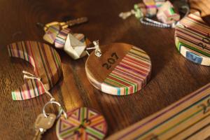 a wooden table with a bunch of keychains on it at Hakuba Pension & Log Hotel Meteor in Hakuba