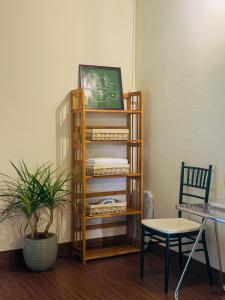 a shelf with a chalkboard and a table and a chair at XOM House - Nhà nguyên căn trung tâm Pleiku in Plei Brel (2)